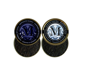 Two tins of Meredith Marks caviar, labeled Sapphire Sevruga and Diamond Ossetra, showcasing premium black caviar.