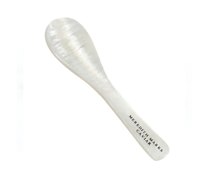 A pearl-handled caviar spoon engraved with Meredith Marks Caviar for serving premium caviar.